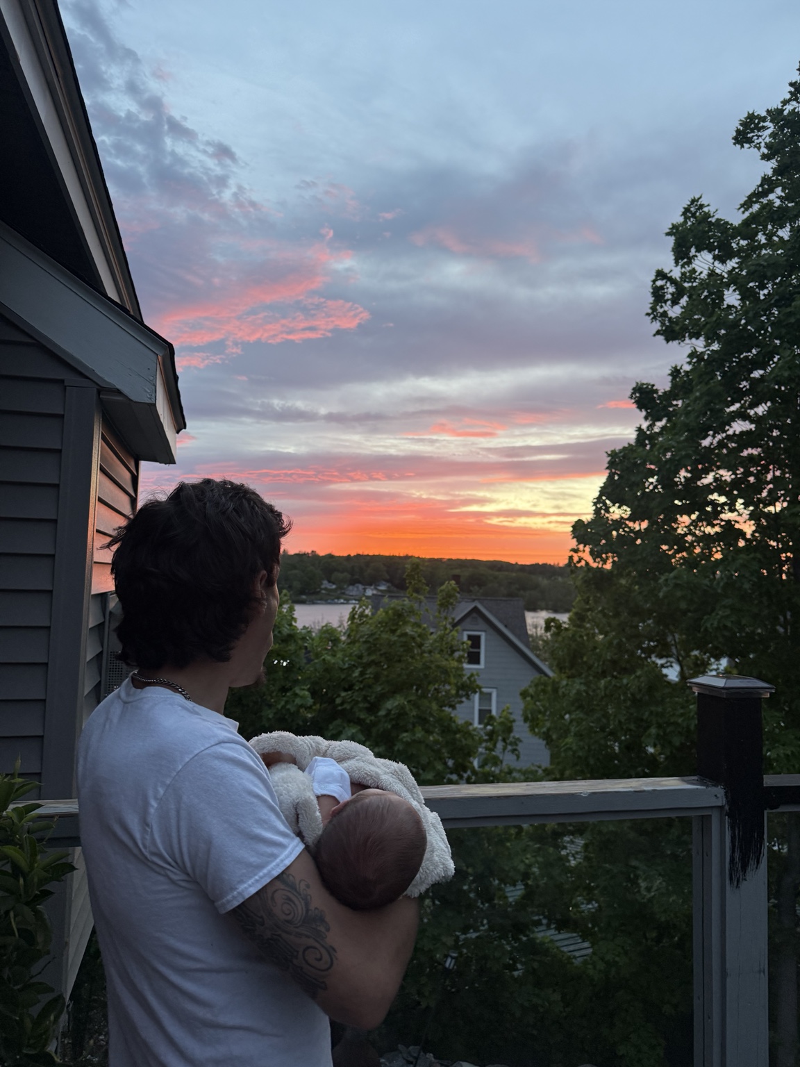 Joseph holding his son at sunset